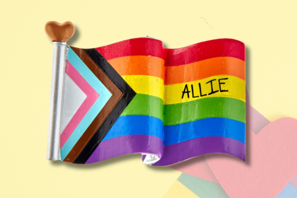 Personalized Pride flag ornament featuring rainbow colors and custom name.