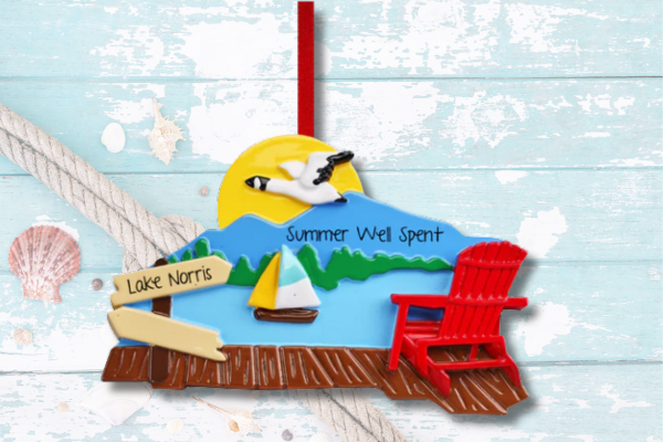 Personalized lake vacation ornament featuring dock, sailboat, sunset, and custom lake name.