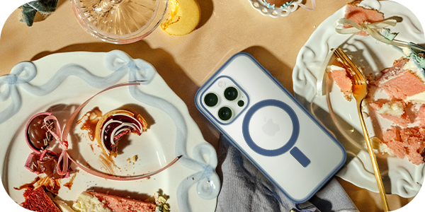 iPhone with Defenders Series case on a table with sweet treats