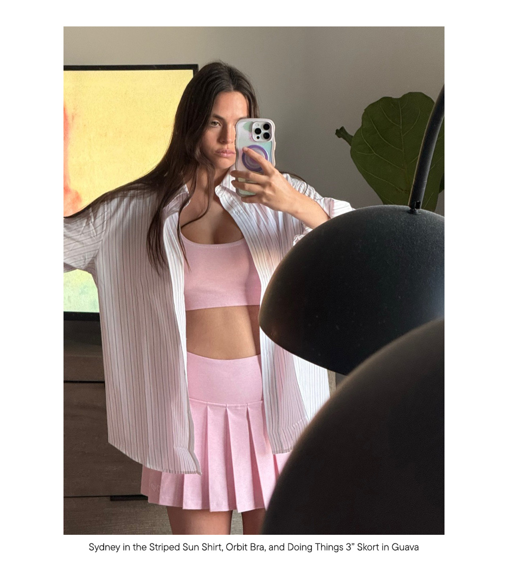 Sydney in the Striped Sun Shirt, Orbit Bra, and Doing Things 3” Skort in Guava 