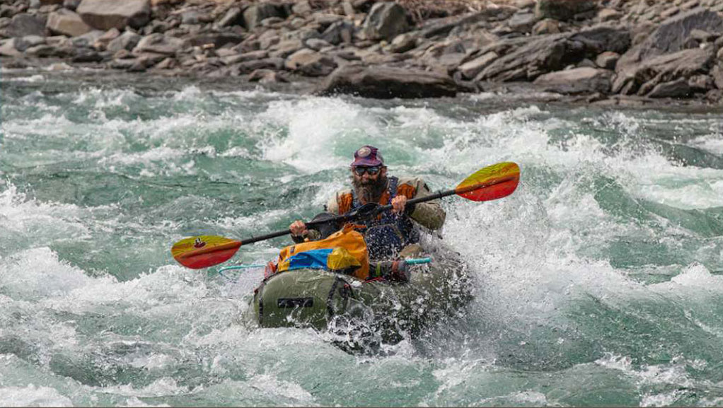 A person rafting in a river.