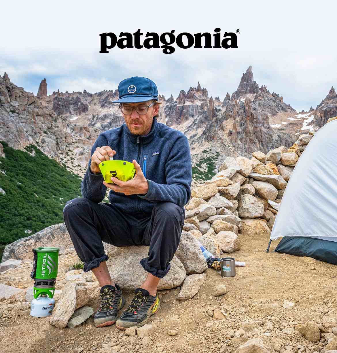 Patagonia. A person sitting on a rock and eating food in the mountains.