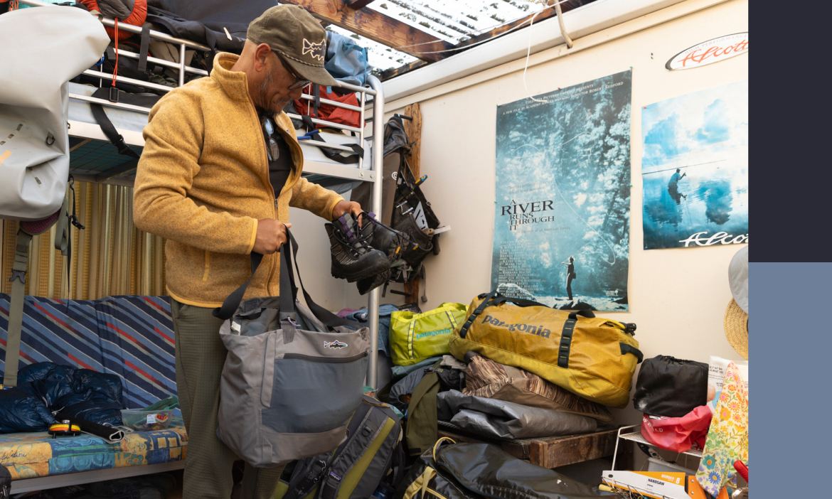 An angler packs his wading boots in a bag. 