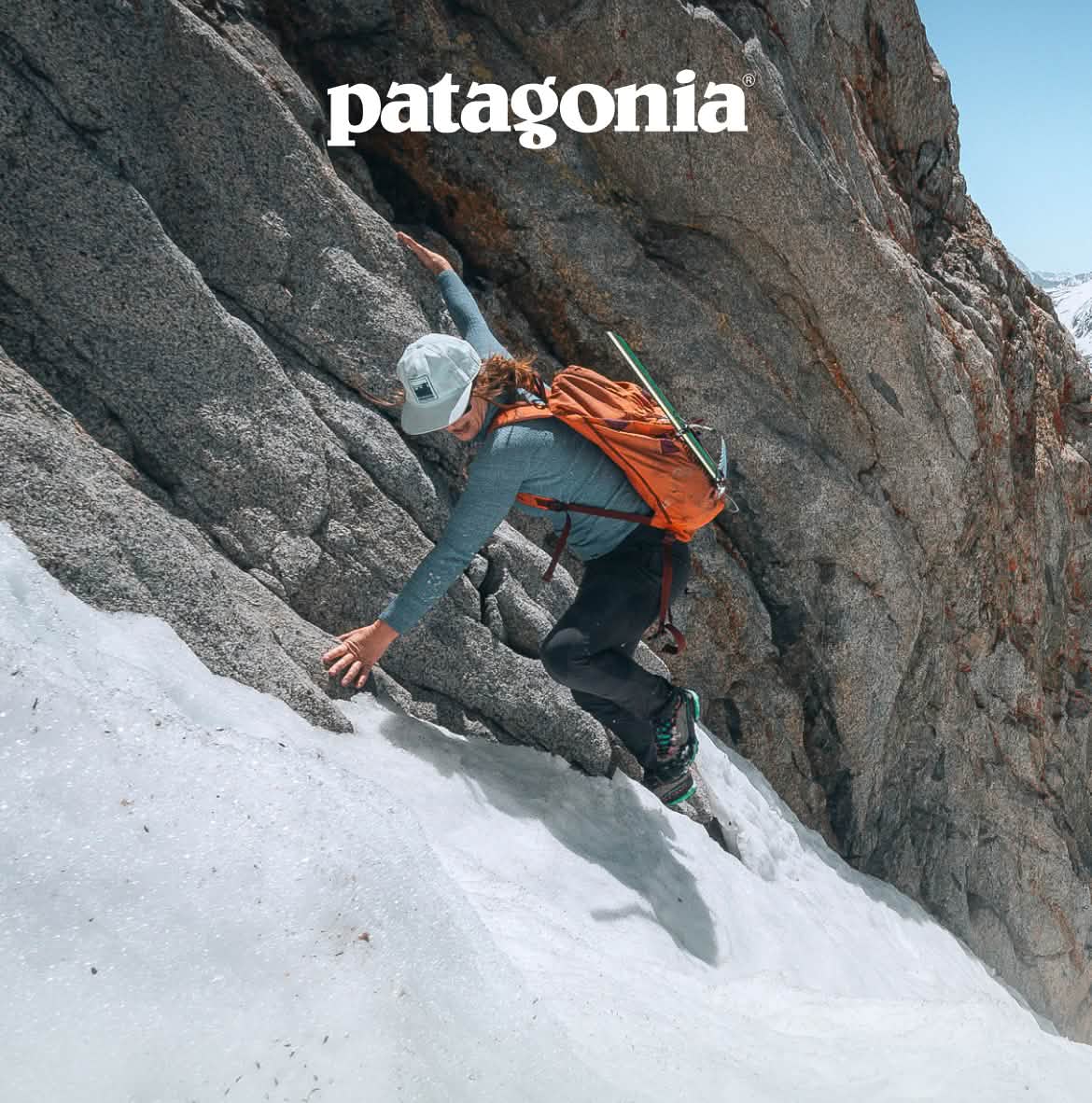 A climber moves from rock to snow.