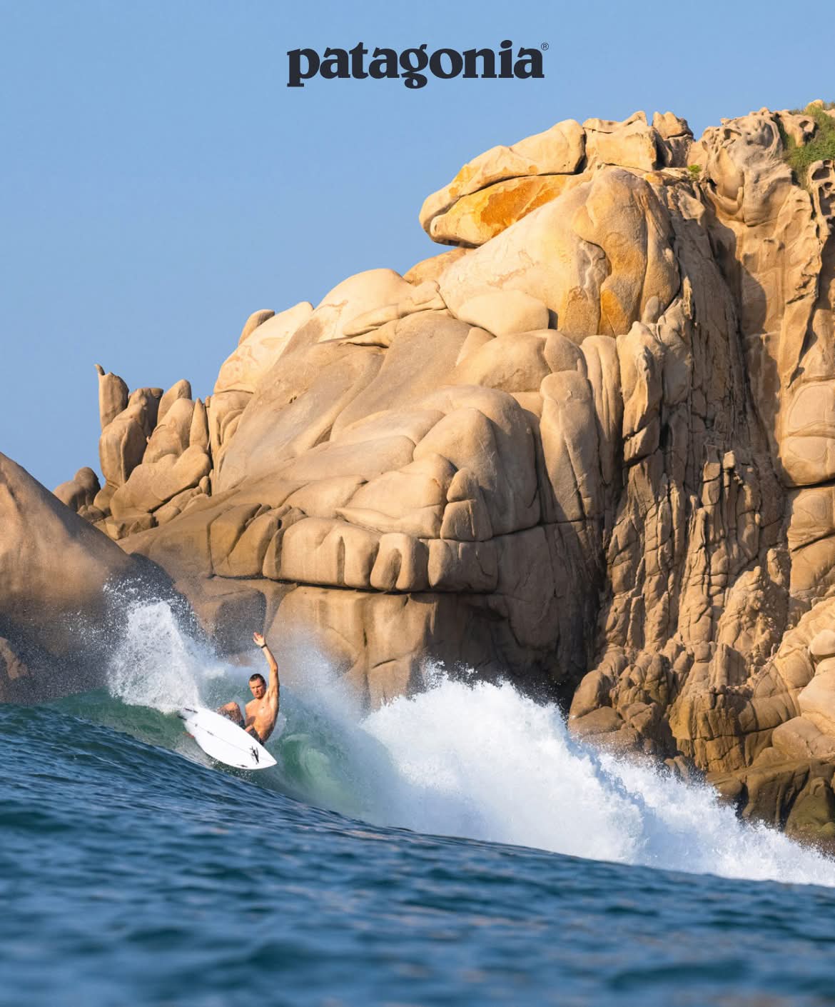 Patagonia. A surfer makes a layback carve in warm water.