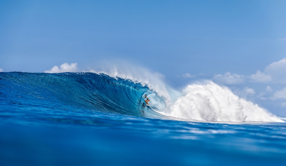 A surfer in a tropical barrel.
