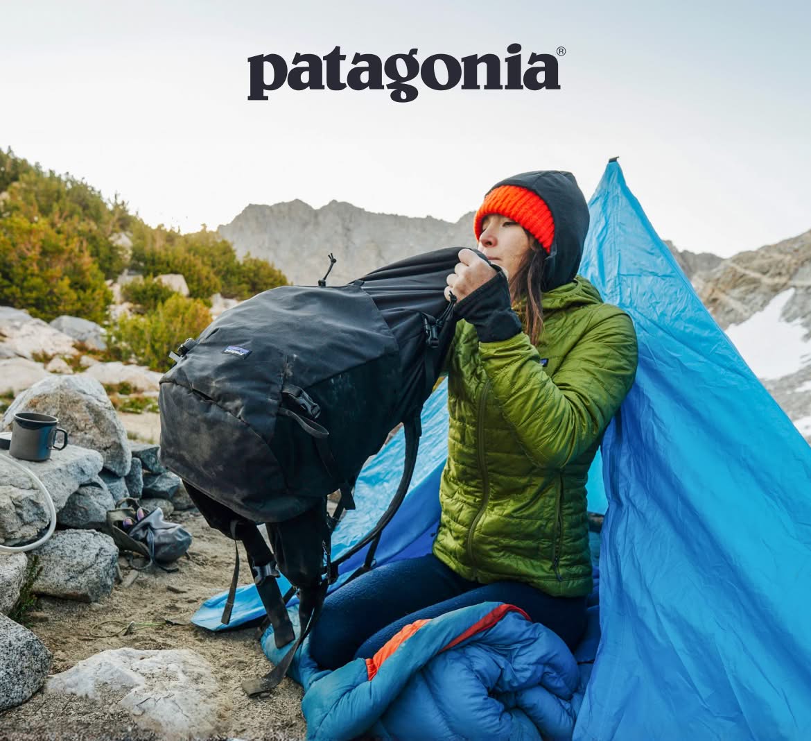 Patagonia. A person loads their backpack in the opening of a tent. 