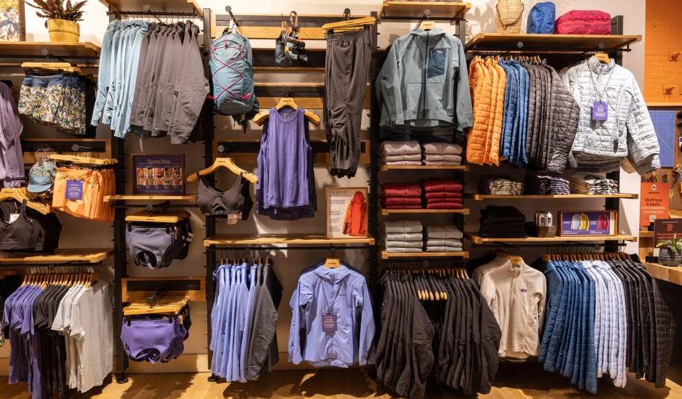 An assortment of clothing inside a Patagonia retail store.