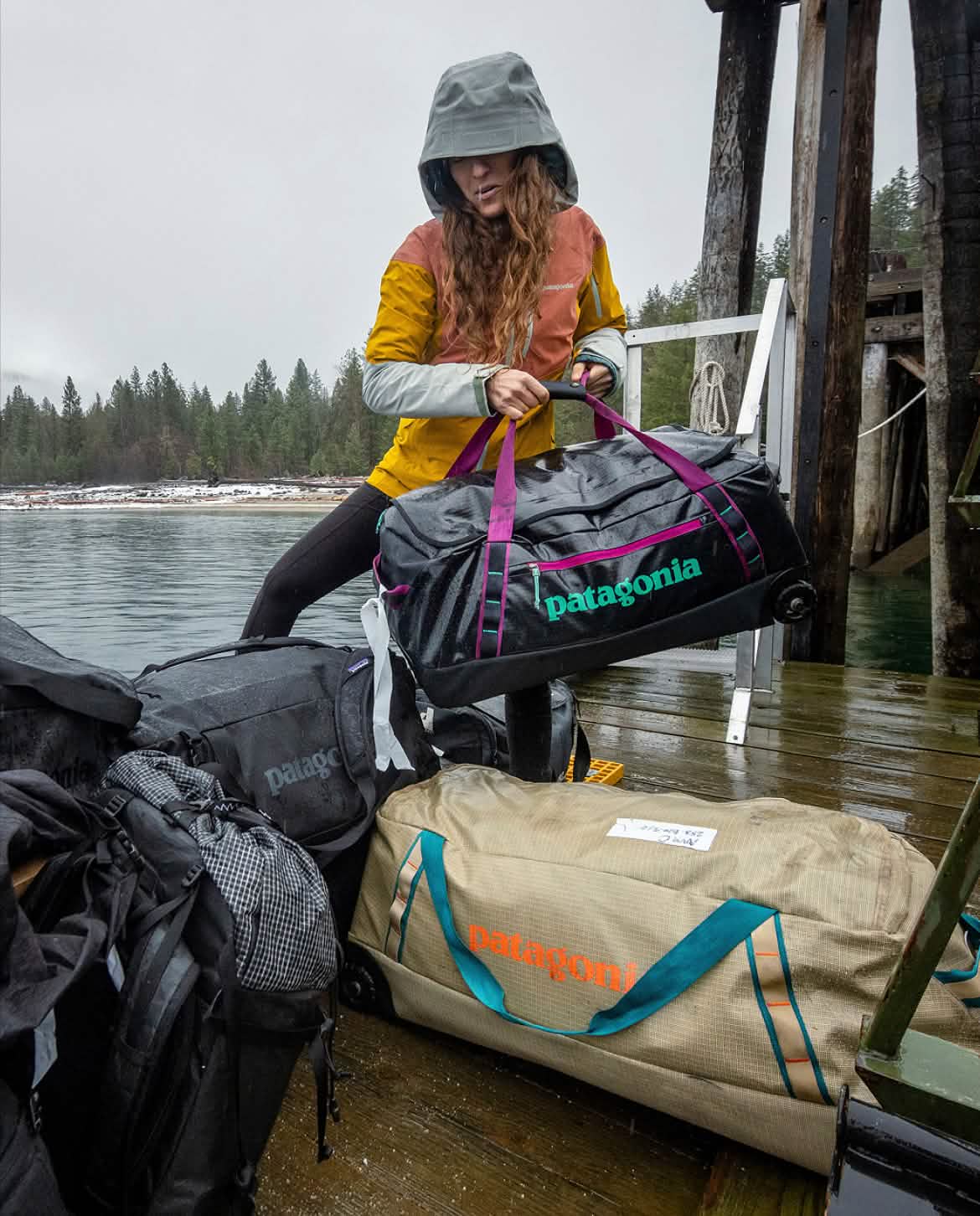 A person stages luggage in the rain.