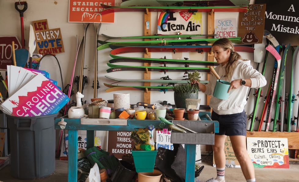 A person inside a garage that’s filled with gear and protest signs.