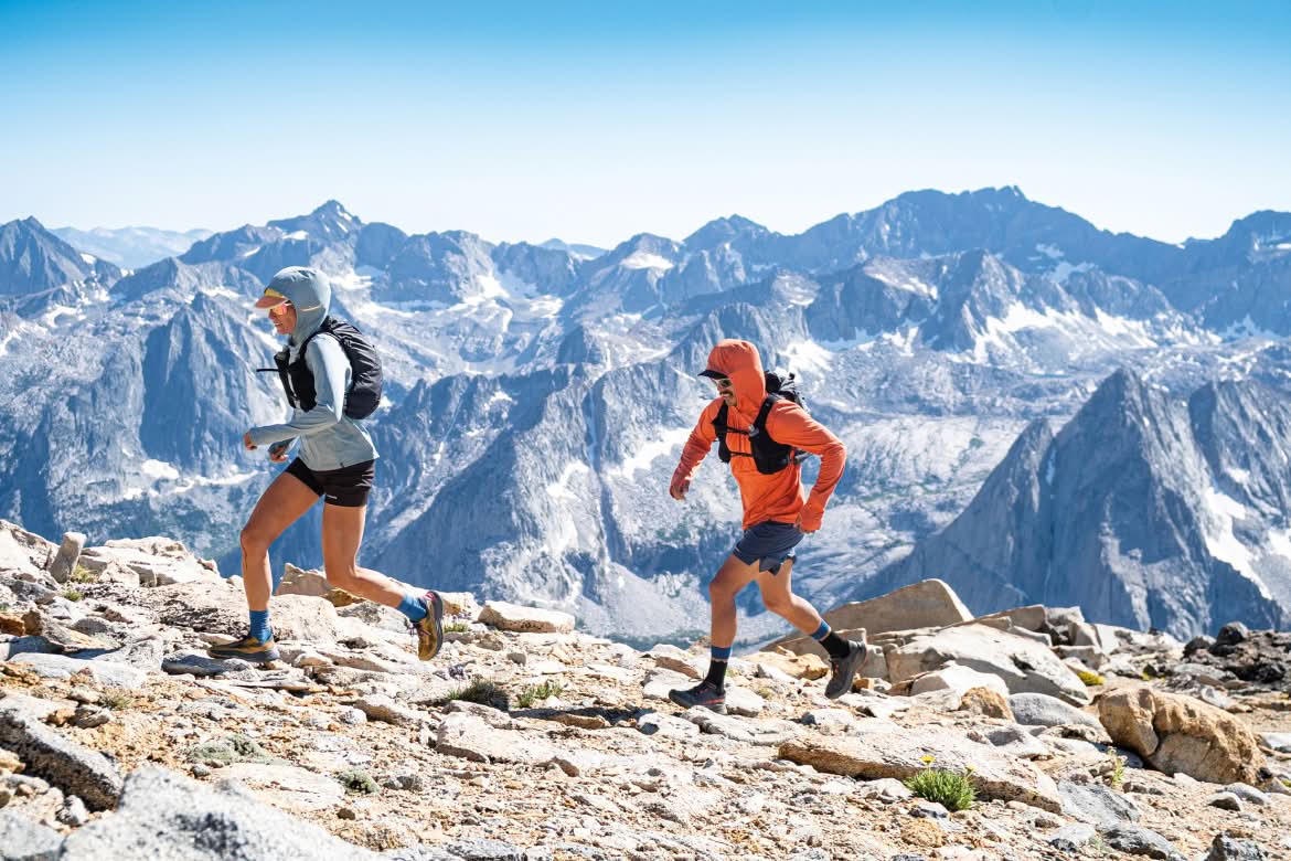  Two people trail run above timberline.