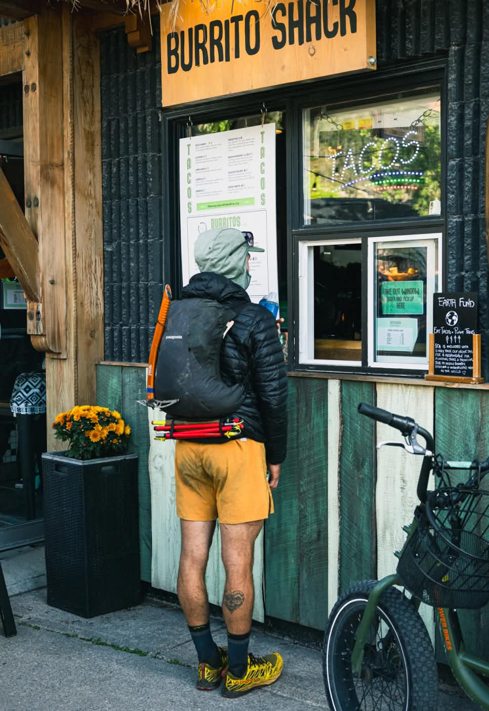 A trail runner waits to place their order at the window of the Burrito Shack.