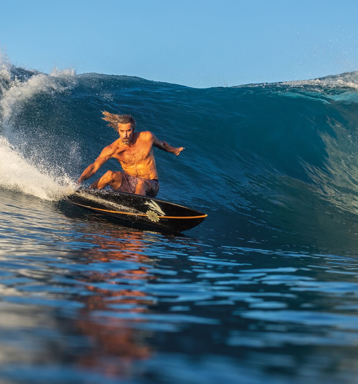 A surfer cuts back to the pocket.