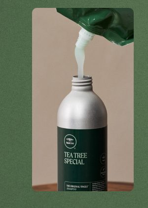 image of Tea Tree Special Refill Pouch being poured into Tea Tree Special Aluminum Bottle