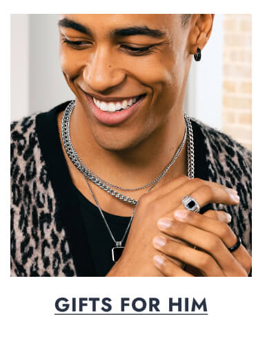 A man poses, wearing Silver and Platinum-Coloured Necklaces. Click here to View Gifts For Him