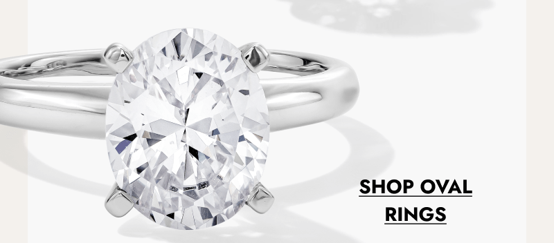 Oval diamond engagement ring on a polished white gold band. Click shop oval rings.
