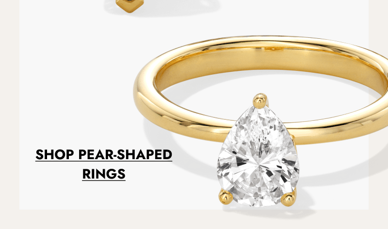 Pear-shaped diamond engagement ring set on a smooth yellow gold band. Click shop pear-shaped rings.