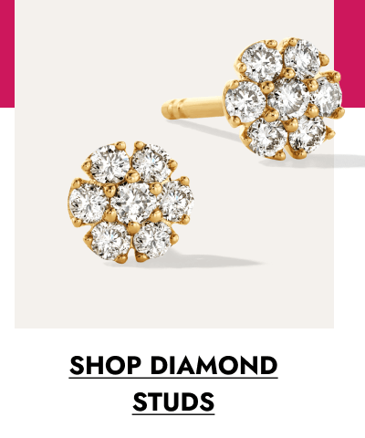 Pair of gold diamond stud earrings in a round cluster design. Click to shop diamond studs.