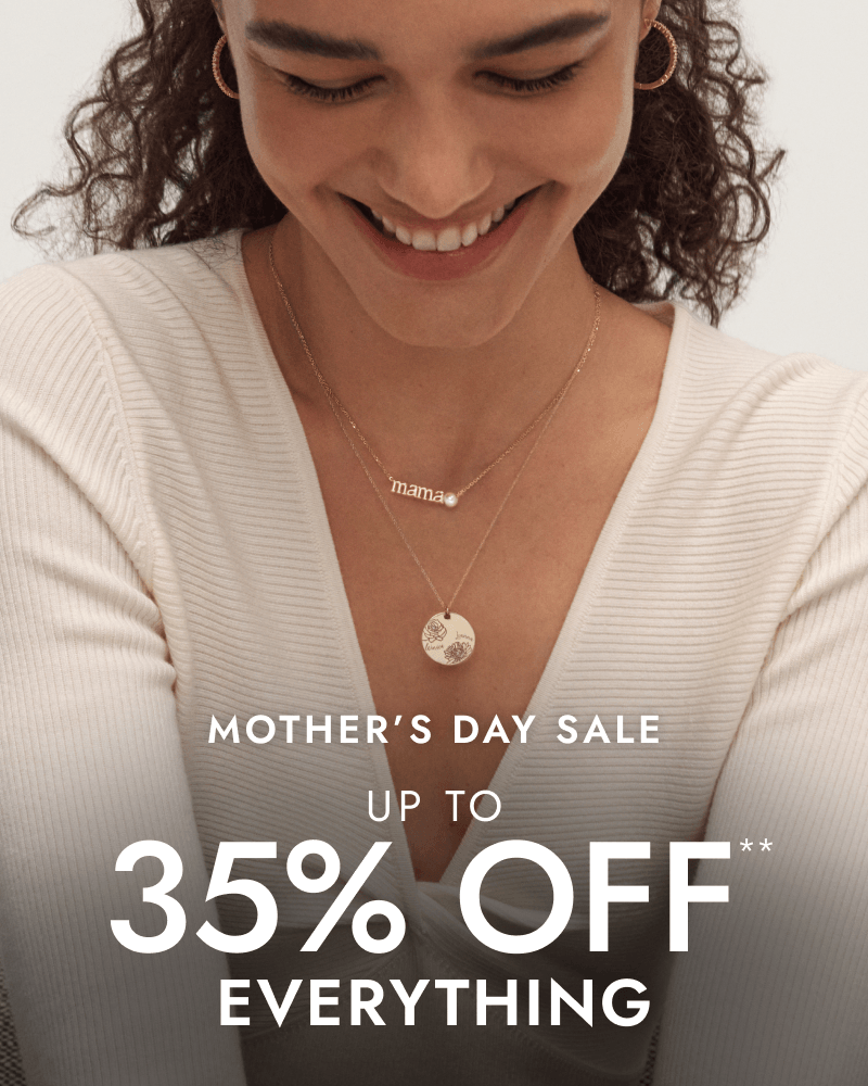 Smiling woman wearing variety of jewellery. Mother’s Day Sale. Up to 35% OFF everything.