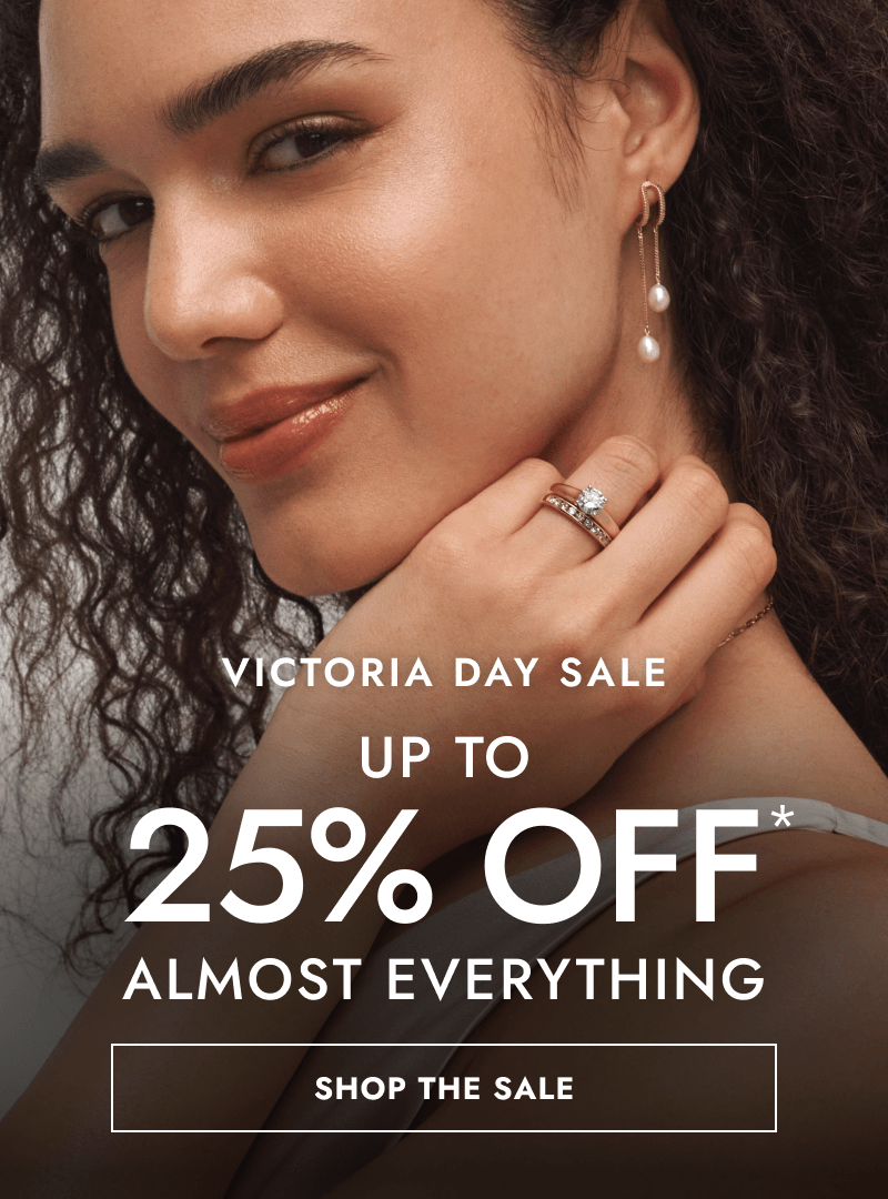 Woman wearing drop pearl earrings and diamond rings. Victoria day sale, up to 25% Off almost everything. Click shop the sale.