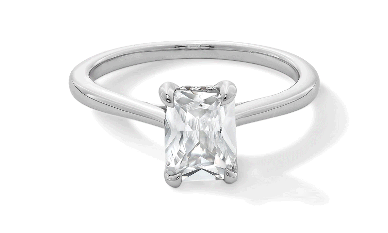 Rotating GIF featuring three styles of solitaire diamond engagement rings in white and yellow gold.
