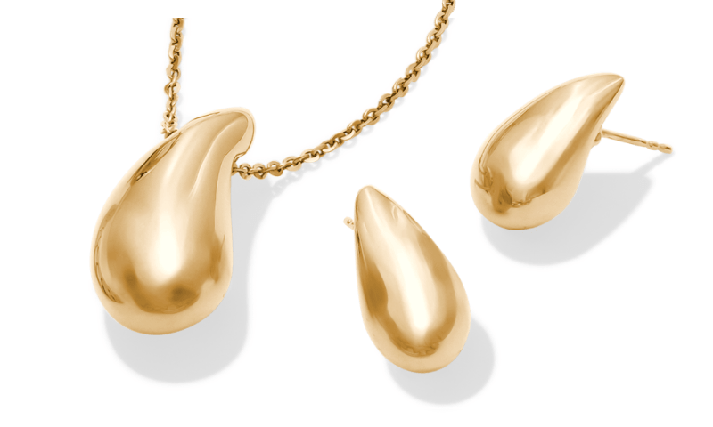 Gold teardrop pendant necklace with matching teardrop stud earrings.