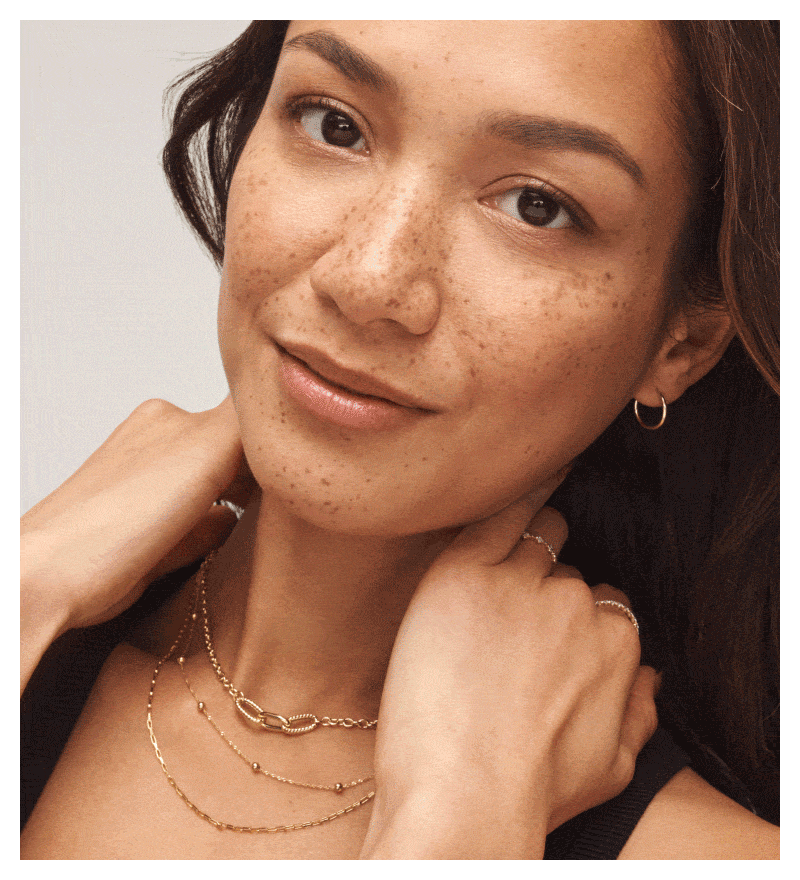 GIF featuring a woman wearing a variety of layered yellow gold jewelry.