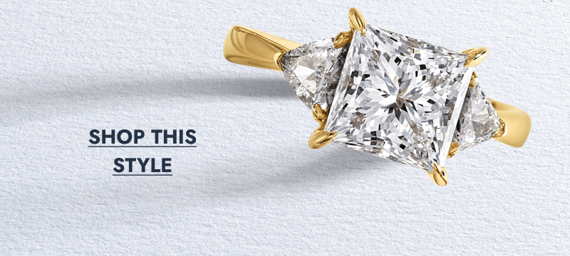 Yellow gold engagement ring with a princess-cut center diamond.&nbsp;