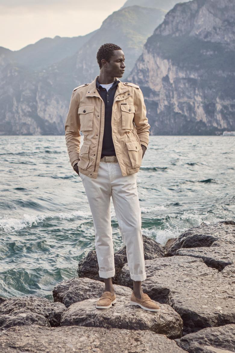 man at the lake with a sahharian jacket, polo and trousers