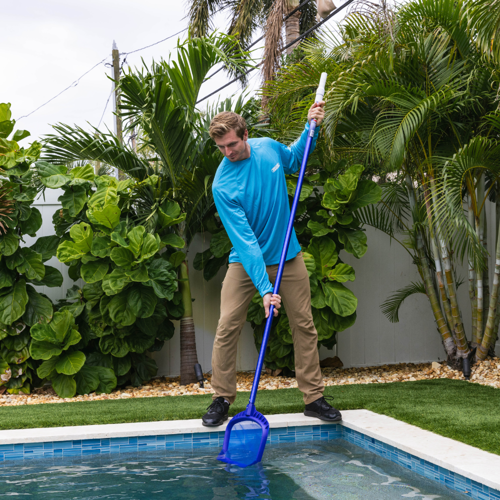 Man skimming swimming pool