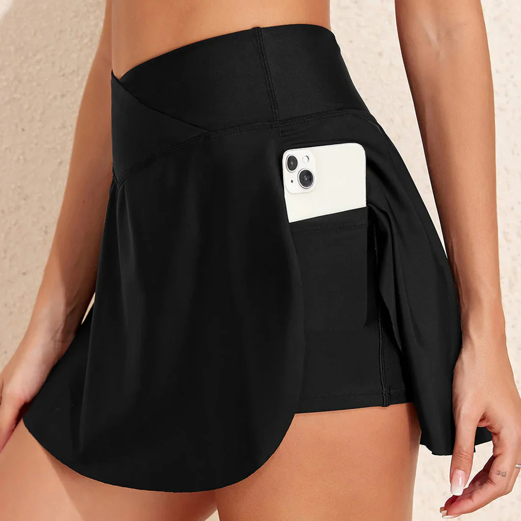 Black athletic skort with phone pocket displaying white smartphone