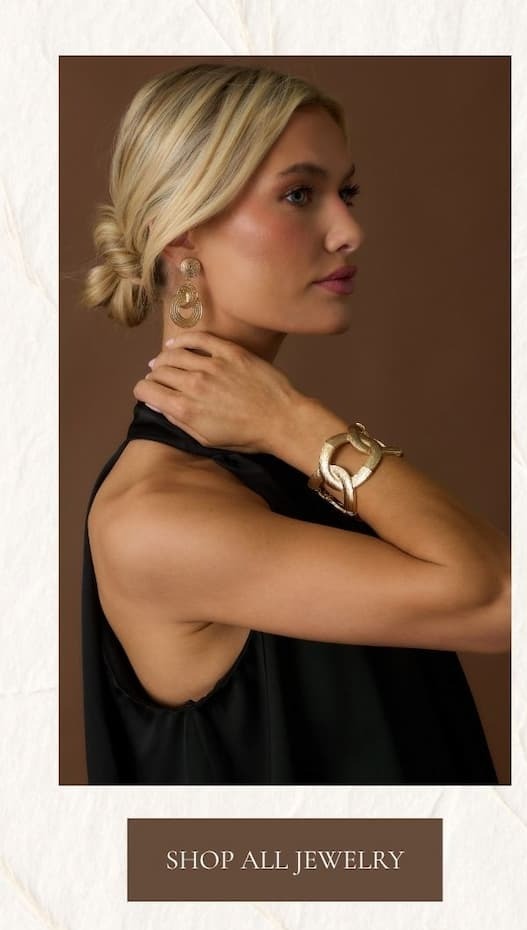 Image of model wearing gold jewelry.