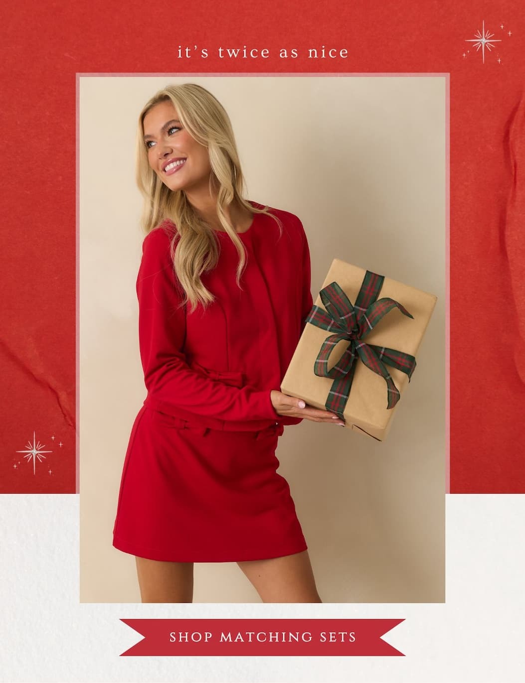 'it's twice as nice.' Image of model wearing a Red Tailored Bow Accent Jacket with matching mini skirt. Button: 'Shop Matching Sets.'