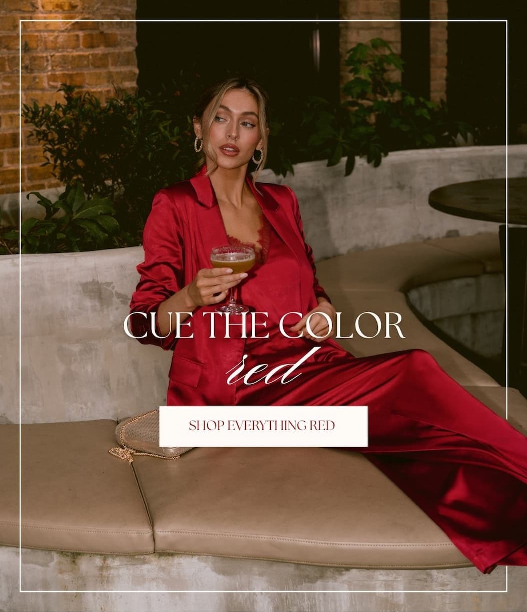 'Cue the color red.' Button: 'Shop Everything Red.' Image of model wearing a red satin blazer with a matching tank top and pants.