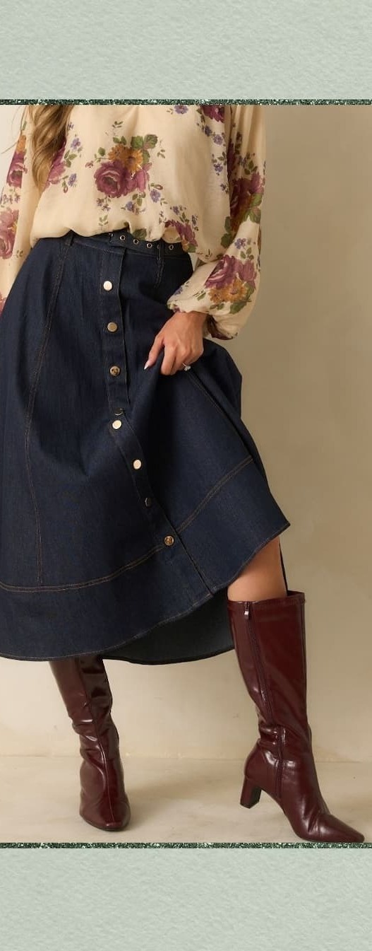 Image of model wearing a dark denim midi skirt.