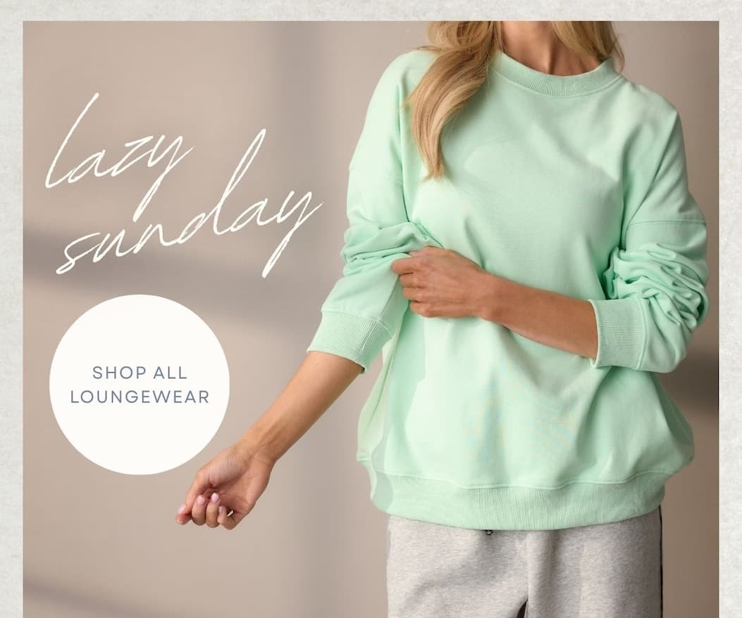 'Lazy Sunday.' Button: 'Shop All Loungewear.' Image of model wearing a mint green sweat shirt.