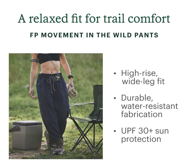 Woman stands near camp chair and cooler. Headline: A relaxed fit for trail comfort. FP MOVEMENT IN THE WILD PANTS. High-rise, wide-leg fit. Durable, water-resistant fabrication. UPF 30+ sun protection