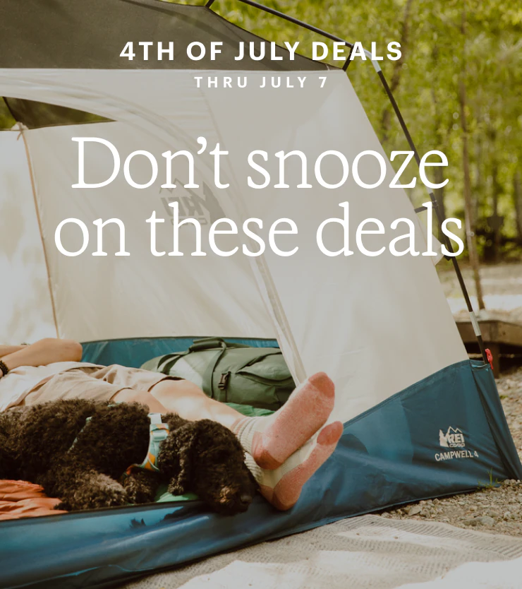 A dog and camper lounging inside a tent. Headline: Don't snooze on these deals. 4TH OF JULY DEALS THRU JULY 7