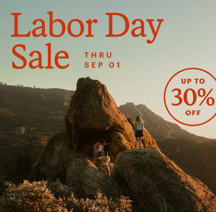 Two explorers posing atop a crag. Headline: Labor Day Sale THRU SEP 1. UP TO 30% OFF