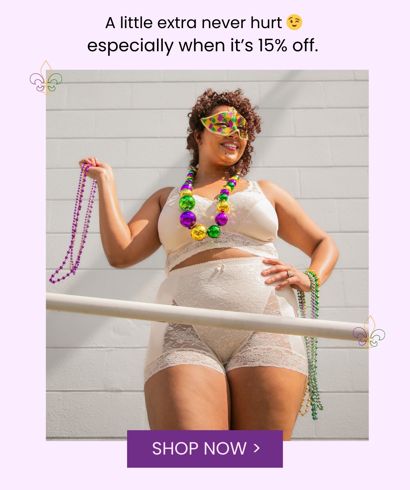 Model in a cream lace bralette and shorts wearing a Mardi Gras mask and holding purple, green, and gold beads while standing on a balcony. Text above reads “A little extra never hurt especially when it’s 15% off” with a purple “Shop Now” button below.