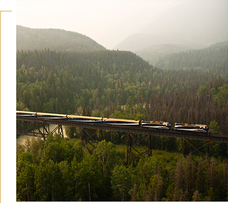 Rocky Mountaineer crossing a bridge on Rainforest to Gold Rush route.