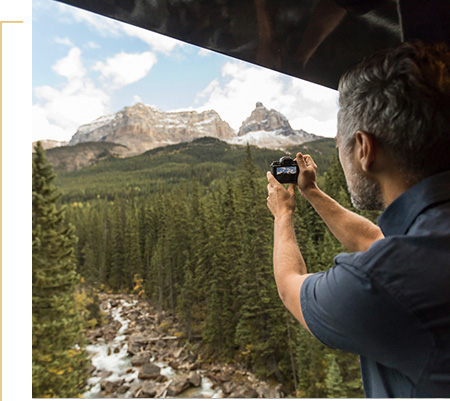 Guest takes photo of scenery from GoldLeaf outdoor viewing platform.