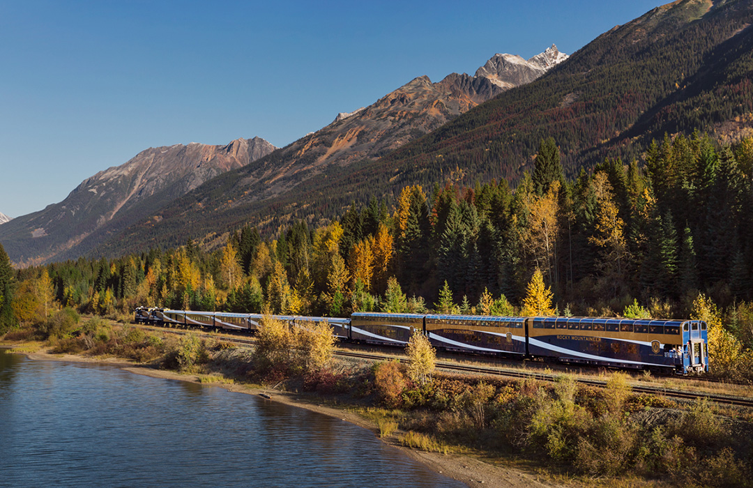Rocky Mountaineer travelling along the water on Journey through the Clouds.