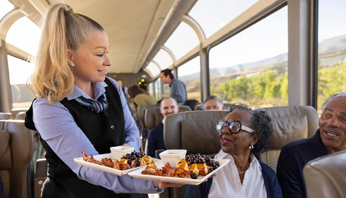 Onboard Host serves meals to guests on the train.
