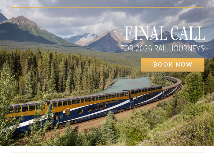Rocky Mountaineer train travelling through mountain scenery.