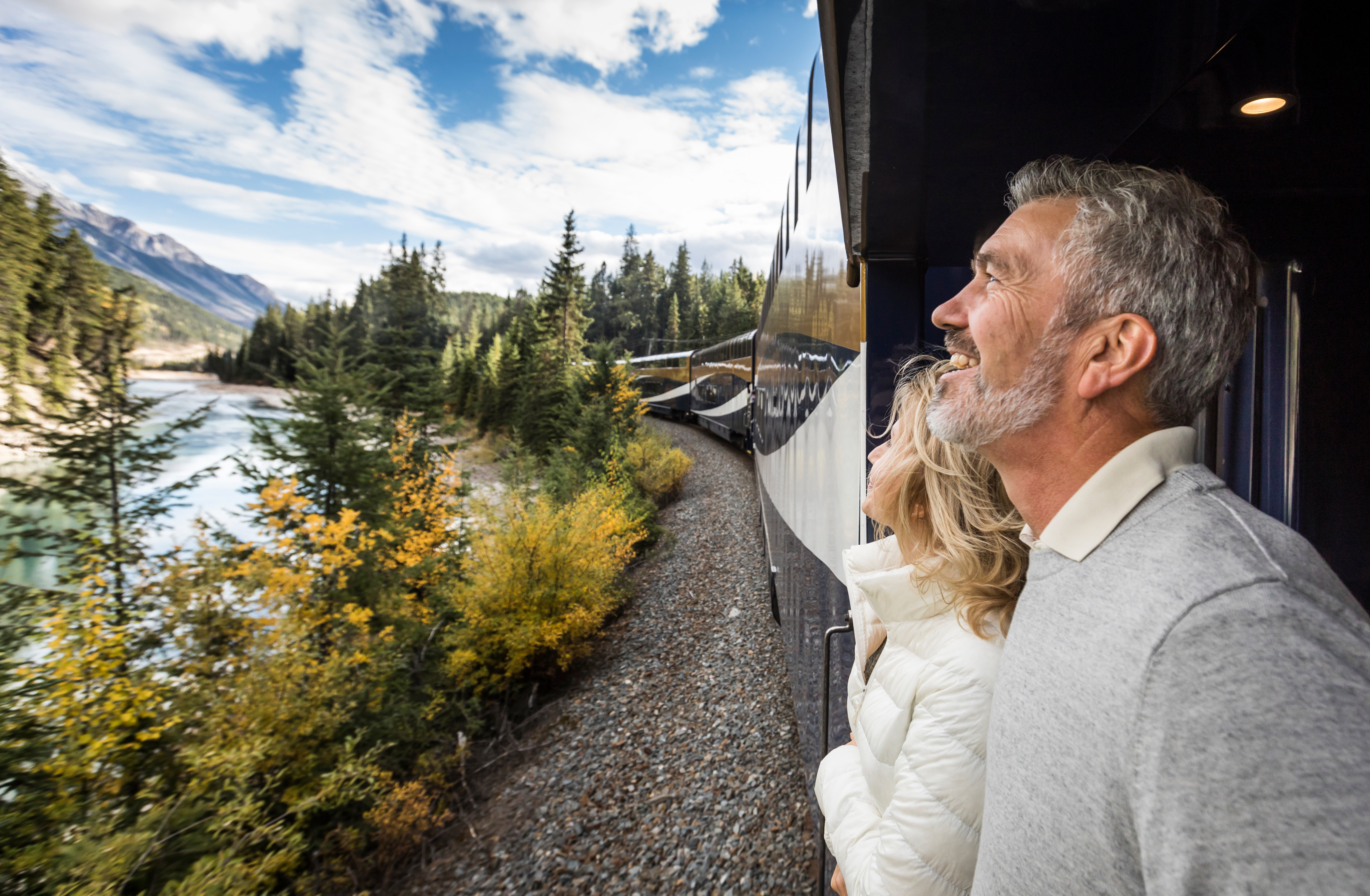 Couple enjoying scenery from outdoor viewing platform.