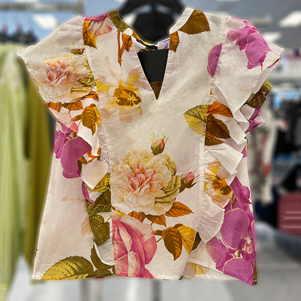 White floral ruffle sleeveless top with fuchsia flowers found in store at Ross. 