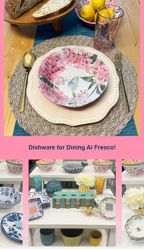A dining setting with a melamine floral bowl on a melamine pearl-edged plate. Gold utensils and a glass are beside it. Bread and lemons are in the background. Dishware for Dining Al Fresco! Table display of decorative bowls, plates, glasses, and planters in various colors, with a bouquet of white flowers and a golden bee ornament found in store at Ross. 