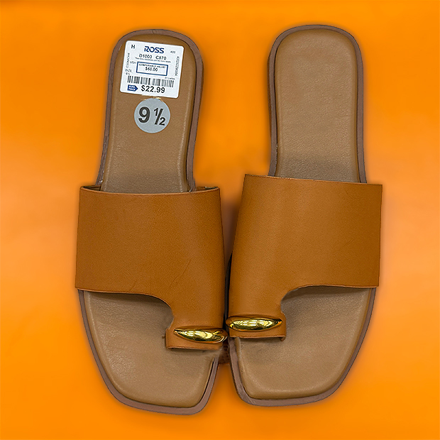 A pair of tan sandals with metal gold toe embellishment found in store at Ross. 