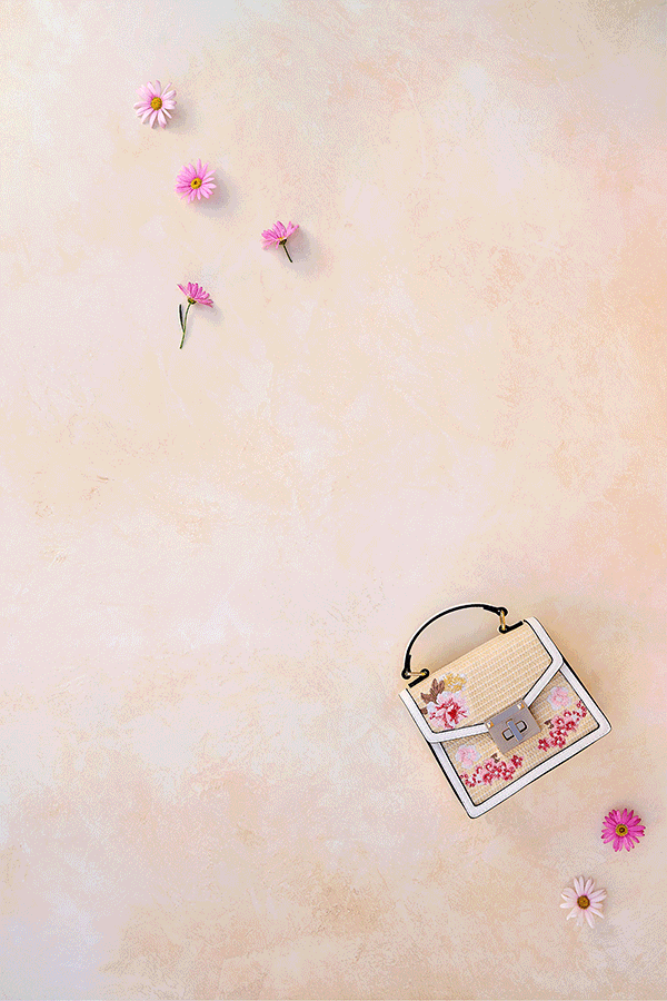 Four floral handbags in rattan, blue, pink and rose colors.  